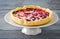 Mix berry tart, pie, cake with raspberries, bilberries, bluberries, red currant and cream, copy space