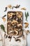 Mix of chopped wild dried mushrooms  on white background  top view flat lay