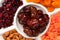 Mix of dried fruits and nuts. Apricot, raisin, cranberry, dates fruit. Isolated on a white background. Space for text or design