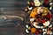 Mix of dried fruits and nuts on a dark wood background with copy space. Top view. Symbols of judaic holiday Tu Bishvat.