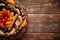 Mix of dried fruits in a small wicker basket on wooden table