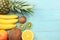 mix of fresh coconut, banana, kiwi fruit, orange and pineapple on blue wooden background. top view with copy space