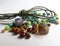 Mix of green, brown, mint and beige glass beads and green leather cord for hobbies including jewelry making and crafts