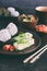 Mix of Japanese food - rice balls onigiri, omelette, ginger, sunomono wakame cucumber salad. Traditional dessert of bean and green