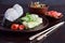 Mix of Japanese food - rice balls onigiri, omelette, pickled ginger, sunomono wakame cucumber salad and chopsticks. Asian