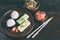 Mix of Japanese food - rice balls onigiri, omelette, pickled ginger, sunomono wakame cucumber salad and chopsticks. Asian