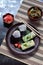 Mix of Japanese food - rice balls onigiri, omelette, pickled ginger, sunomono wakame cucumber salad and chopsticks. Asian