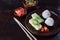 Mix of Japanese food - rice balls onigiri, omelette, pickled ginger, sunomono wakame cucumber salad and chopsticks. Asian