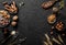 Mix of nuts and spices for baking cakes in bowl and spoon, cinnamon, star anise, hazelnuts, walnuts, wheat, lavender on dark table