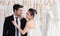 Mix race wedding concept, Happy couple spent time together while choosing or fitting wedding dress and tuxedo in fitting room,