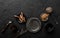 Mix of spices for baking cakes in bowl and spoon, cinnamon, star anise, hazelnuts, walnuts, wheat, lavender on dark stone table