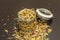 Mix of variety of cereals in glass jar on black stone background