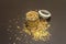 Mix of variety of cereals in glass jar on black stone background