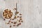 Mixed almonds in a bowl on a wooden background.