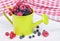Mixed berries in small decorative watering can
