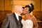 mixed black african bride kiss by caucasian groom in wedding