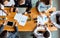 Mixed Business Team Working Sitting At Table In Office, Above-View