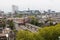 Mixed classic architecture of Rotterdam leafy urban apartment buildings in foreground with modern city high rise, tall towers and