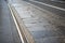 Mixed cobbles pavÃ¨ and tarmac city road with tramway tracks in Turin