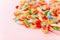 Mixed collection of colorful candy, on pink background. Close up