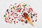 Mixed colorful berries in waffle cone on white table top view in flat lay style.