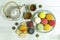 Mixed colorful french macaroons on plate and wooden table with t