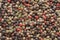 Mixed colorful peppercorn background. Close up.