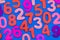 Mixed coloured numbers on a blue background.