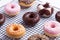 Mixed donuts on grid, on white background