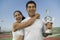 Mixed doubles Tennis Players standing in tennis court holding trophy portrait