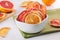 Mixed dried citrus orange and grapefruit slices in a white ceramic bowl
