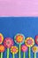 Mixed felt flowers on blue background with empty place for text. Variegated flower applique for kids