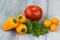 Mixed fresh colored vegetables, cherry tomatoes, mini paprika, tomato and fresh herbs on a wooden background