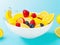 mixed fruits and water floating on white bowl. Image is generated with the use of an ai
