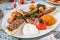 Mixed grill on wooden table. Lamb chops, Adana kebab, chicken shish, shish meatballs, steak