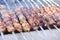 Mixed grilled meat platter. Assorted delicious grilled meat. The closeup of some meat skewers being grilled in a barbecue. grilled