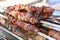 Mixed grilled meat platter. Assorted delicious grilled meat. The closeup of some meat skewers being grilled in a barbecue. grilled