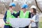 Mixed group of architects and business partners discussing project details during inspection of a construction site