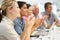 Mixed group clapping in business meeting