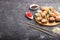 Mixed japanese maki sushi rolls set with chopsticks, ginger, soy sauce,rice on black concrete background, side view