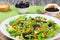 Mixed lettuce, spinach, carrot, ham, cheese and prunes salad , top-view