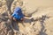 Mixed little toddler boy playing in sand on beach