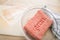 Mixed minced meat of pork and beef from plastic tray packaging in bowl on cutting board for cooking in domestic kitchen