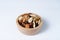 Mixed nut and raisin snack in wooden bowl, isolate background