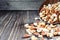 Mixed nuts spilling out of bowl on wooden table. Macro still-life with shallow dof