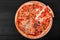 Mixed pizza Italian food with chicken, tomatoes, mushrooms, ham, salami, olive and cheese on dark wooden background. Homemade