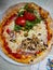 Mixed pizza with vegetables, sea creatures, mushrooms, olives.