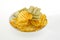 Mixed potato crisps and corn flake cereal on white background