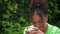 Mixed race African American girl biracial teenager young woman outside wearing a face mask during COVID-1