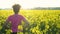 mixed race African American girl teenager female young woman runner resting after jogging in field of yellow flowers